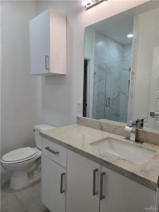 Bathroom with vanity and a marble finish shower | Image 6