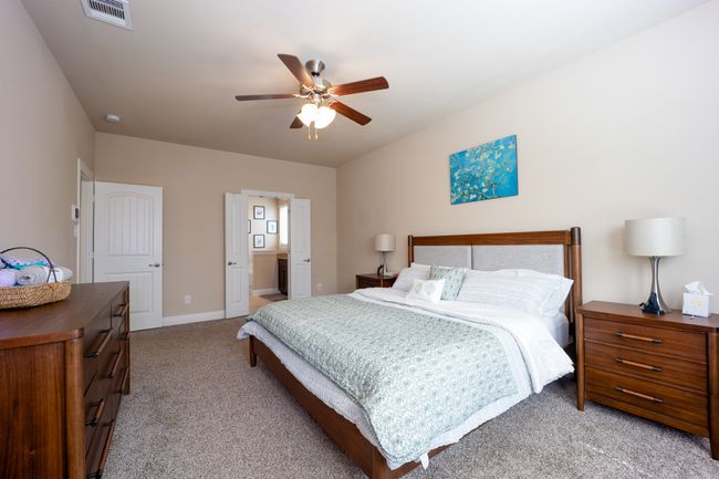Bedroom with light colored carpet and a ceiling fan | Image 13