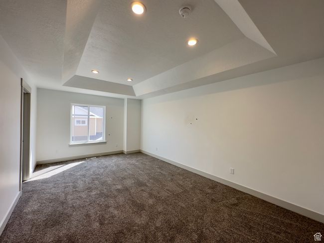 Master bedroom featuring a raised ceiling | Image 8