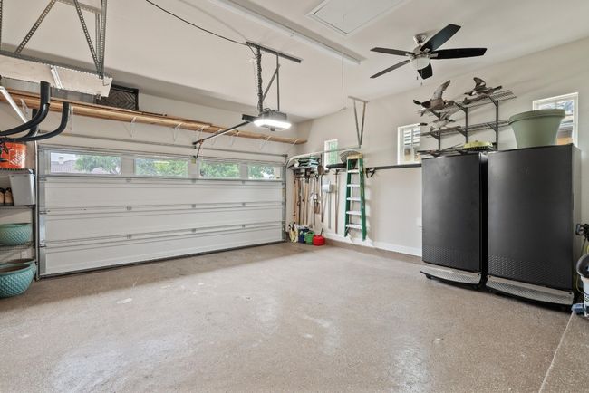 Garage with a garage door opener and ceiling fan | Image 28