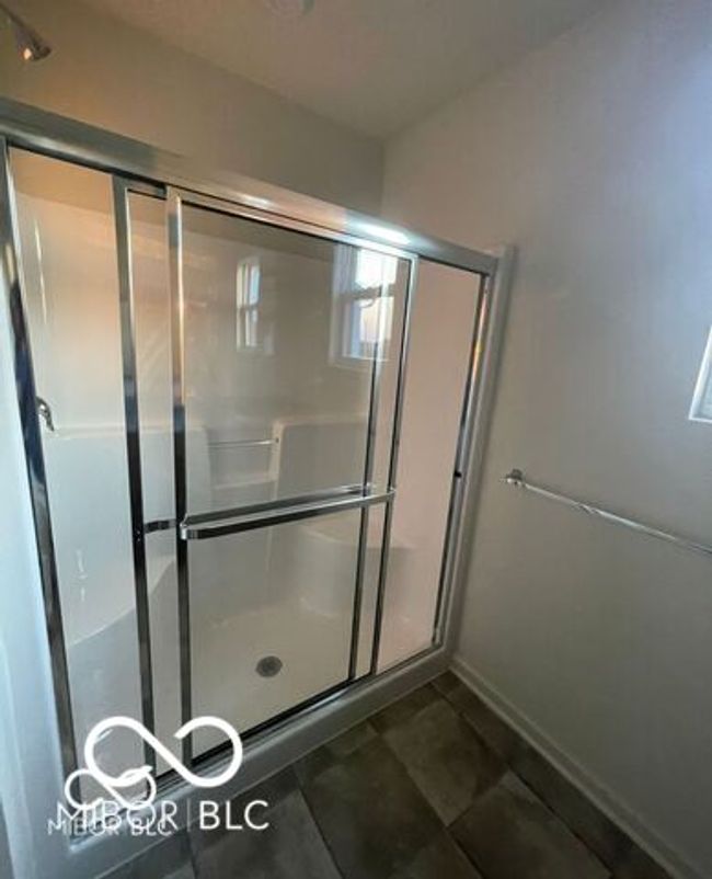 full bath featuring baseboards and a shower stall | Image 15