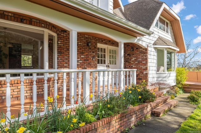 View of side of property with covered porch, brick siding, and roof with shingles | Image 4