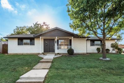 Single story home with a porch and a front yard | Image 1