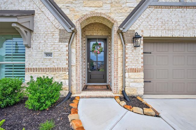 The welcoming front porch, framed by layered brickwork and soft landscaping, sets a warm and tasteful tone as you arrive. | Image 4