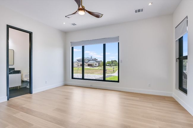 Spare room featuring light wood finished floors, plenty of windows, ceiling fan, and recessed lighting | Image 29