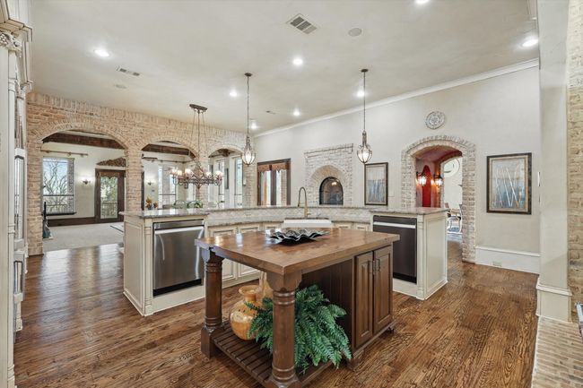 The kitchen island has storage and pasta drawers | Image 18