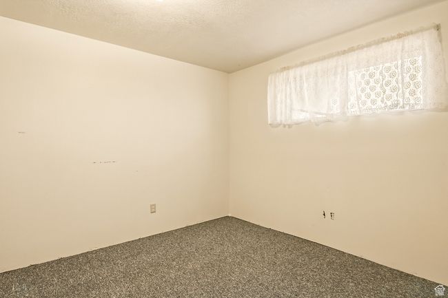 Unfurnished room with carpet floors and a textured ceiling | Image 32