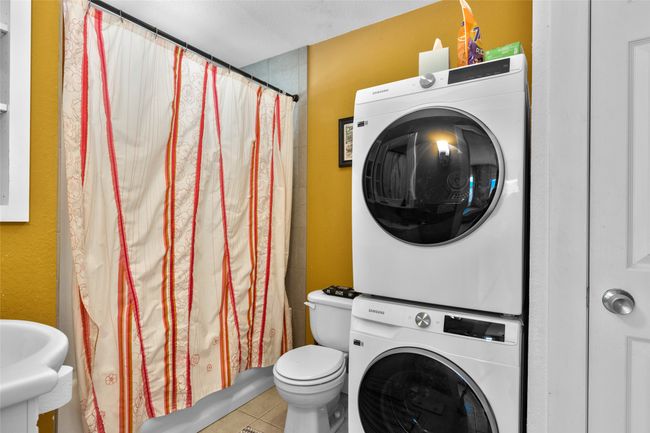 Clothes washing area with stacked washer and clothes dryer | Image 37