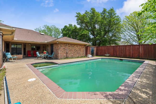 View of swimming pool with a fenced backyard, a fenced in pool, an in ground hot tub, and a patio | Image 34