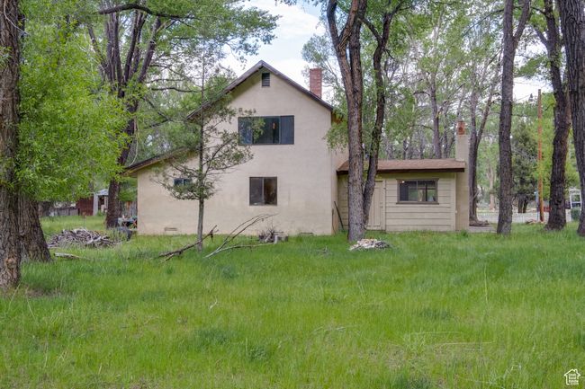 Back of property with a chimney and stucco siding | Image 9
