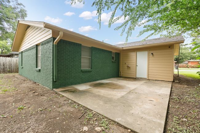 Rear view of house with brick siding and a patio | Image 19