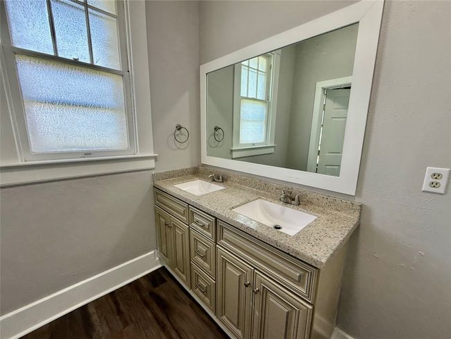 Full bath featuring double vanity and wood finished floors | Image 13