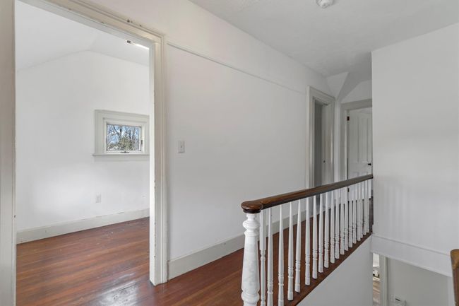 Corridor with wood finished floors, an upstairs landing, and baseboards | Image 34