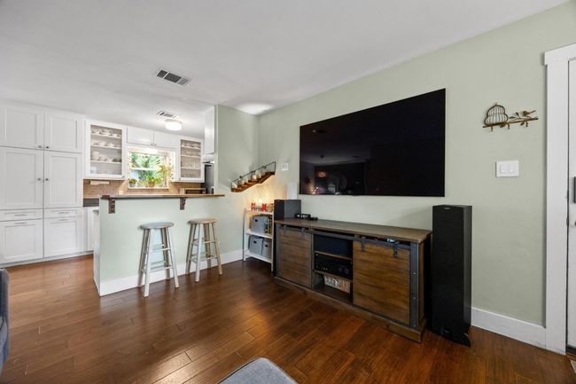 Living room featuring baseboards and dark wood-style floors | Image 5