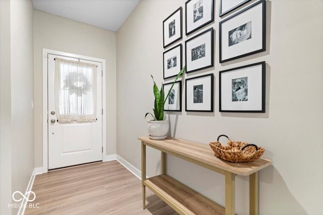 doorway to outside with baseboards and light wood finished floors | Image 4