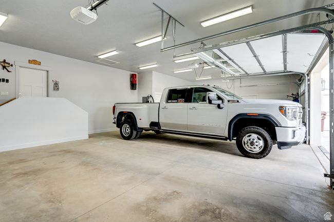 Garage with a garage door opener and baseboards | Image 110