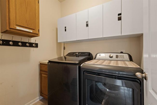 The laundry room features washer and dryer connections, andplenty of storage space. | Image 22