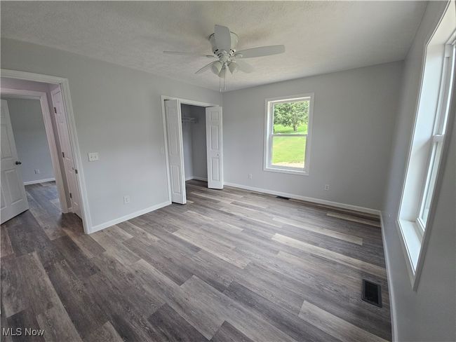 Bedroom 1 with large closet, ceiling fan and plenty of light | Image 18
