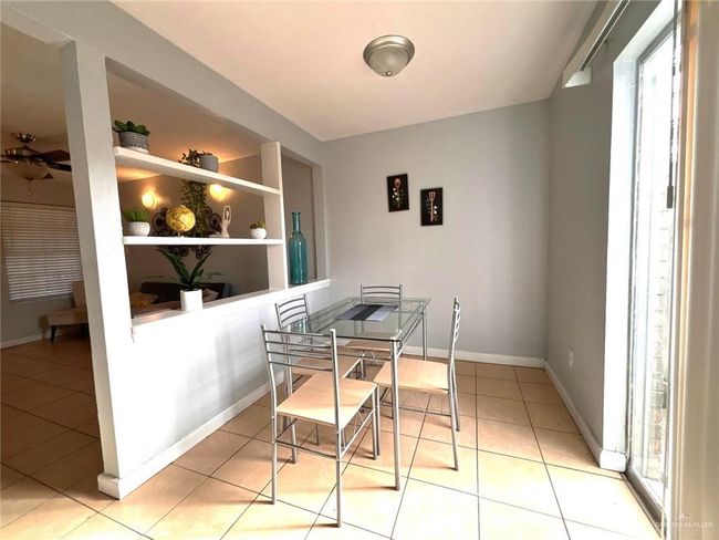 Dining area featuring built in shelves, baseboards, and light tile patterned floors | Image 5