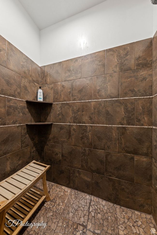 Bathroom with stone finish floors and tiled shower | Image 72