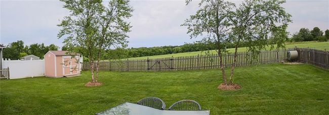 Fenced backyard with a shed | Image 16