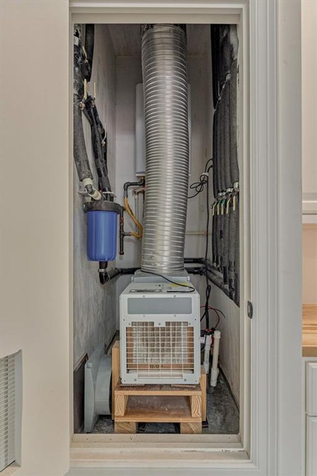A dedicated dehumidifier in the garage closet helps maintain a climate-controlled environment, complemented by two filtered fresh air supply vents that ensure proper airflow and improved air quality. | Image 40