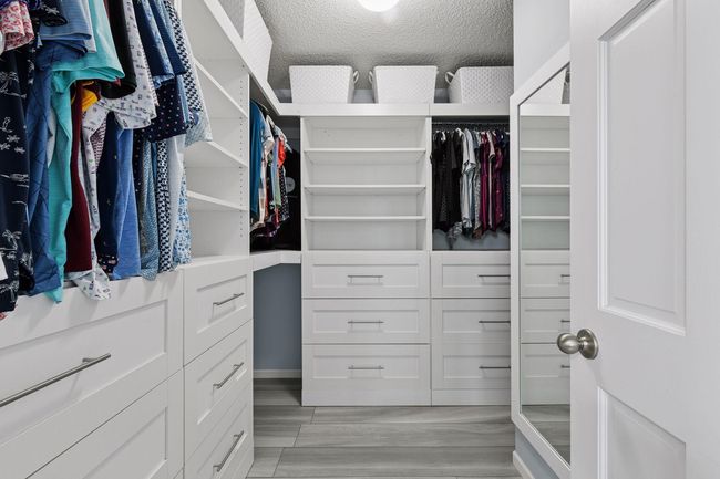 Custom walk in closet with tons of storage | Image 14