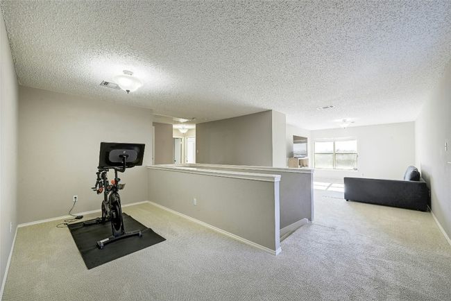 Workout room with carpet flooring and a textured ceiling | Image 17