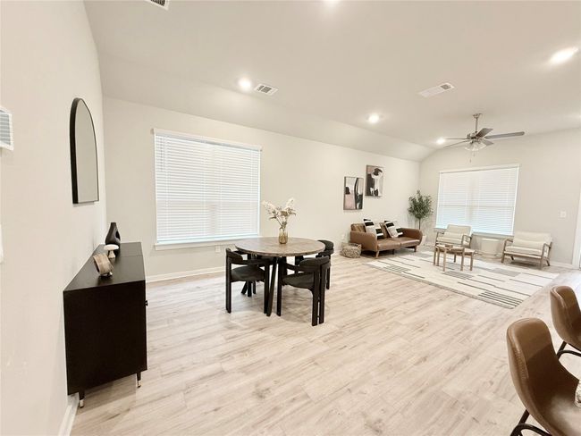 Dining area with visible vents, baseboards, and ceiling fan | Image 12