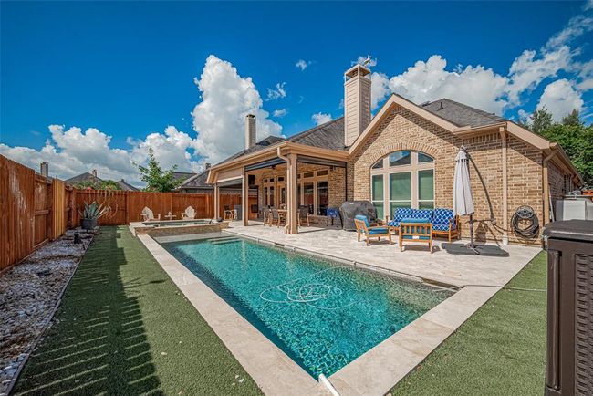 Chlorine Pool is surrounded by astroturf. Astroturf offers a low-maintenance, green year-round solution that eliminates the need for mowing, watering, or fertilizing. | Image 32