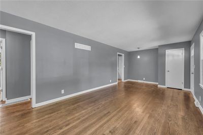 Empty room with a textured ceiling and hardwood / wood-style floors | Image 3