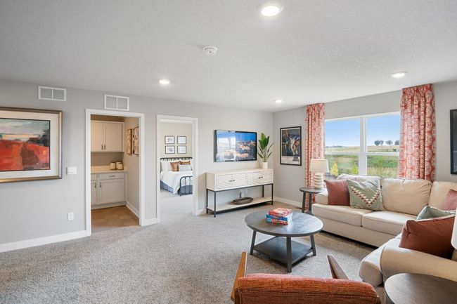 Relax, play and enjoy! This upper-level game room provides an additional 270 square feet of living space and is conveniently located adjacent to all four upper-level bedrooms. Model photo. Options and colors will vary. | Image 16