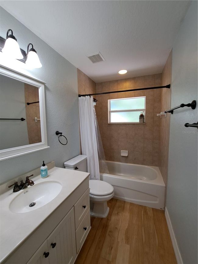 Guest Bathroom features a shower/tub combo. Nicely updated. | Image 14