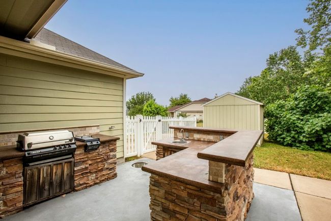 View of patio with an outdoor kitchen and a sink | Image 29