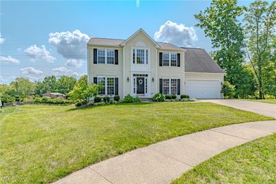 Colonial house with a garage and a front lawn | Image 2