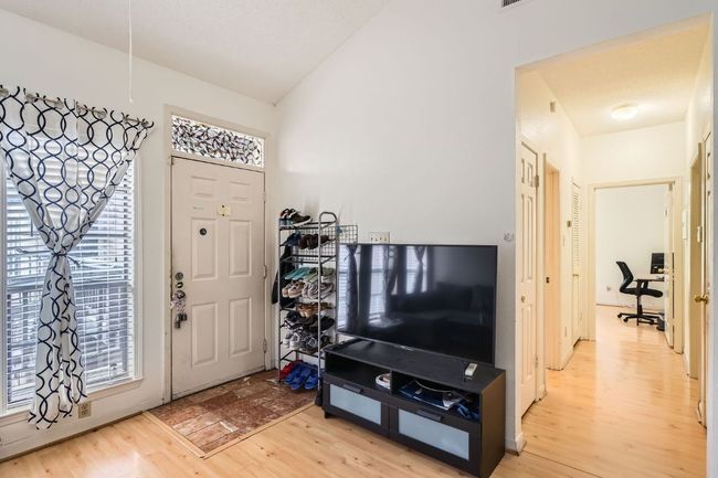 Foyer with lofted ceiling, a healthy amount of sunlight, and light wood-type flooring | Image 8