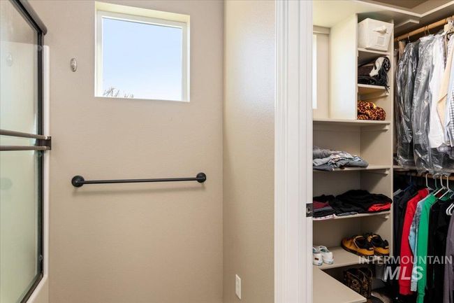 Bathroom featuring a shower with door and a walk in closet | Image 14