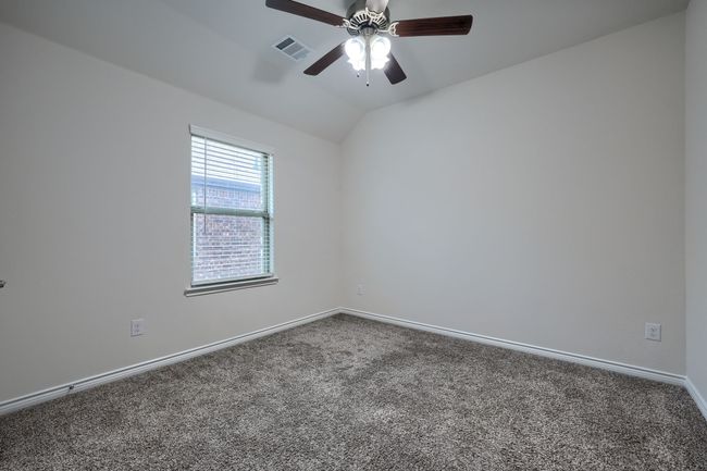 Carpeted spare room with a ceiling fan, baseboards, and lofted ceiling | Image 26