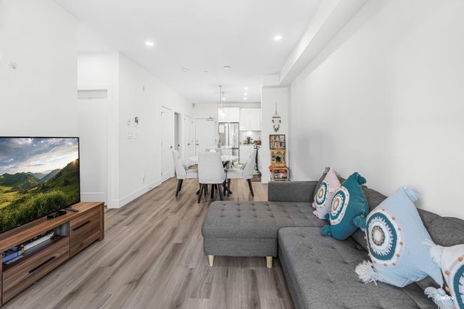 Living area with light wood-type flooring and recessed lighting | Image 10