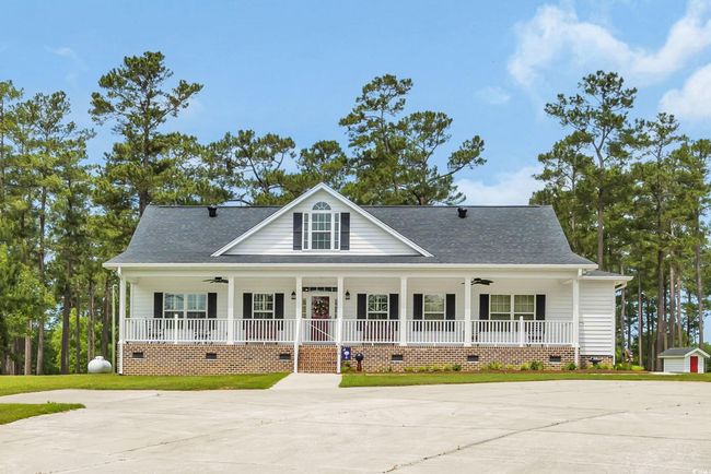 View of front of house with crawl space, a porch, and a ceiling fan | Image 4