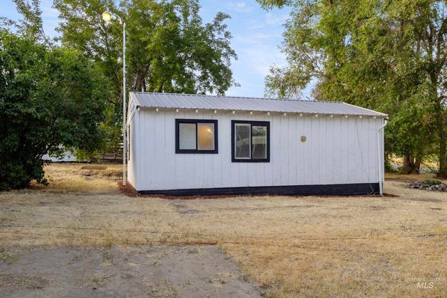 View of property exterior featuring a metal roof | Image 6