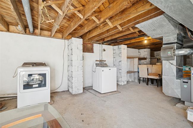 Unfinished basement with heating unit and separate washer and dryer | Image 38