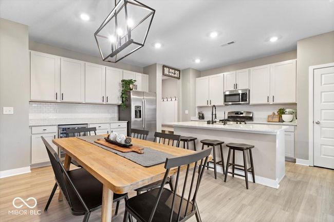 dining space with light wood-style flooring and recessed lighting | Image 18