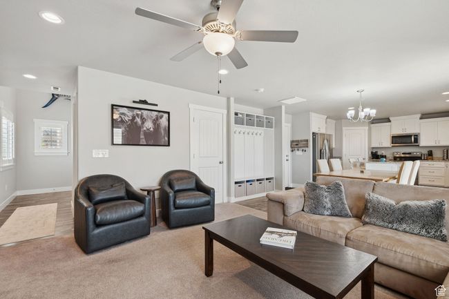 Living room with a chandelier, recessed lighting, and a ceiling fan | Image 6