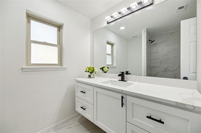 This charming guest bathroom features a bathtub and shower combo. | Image 18