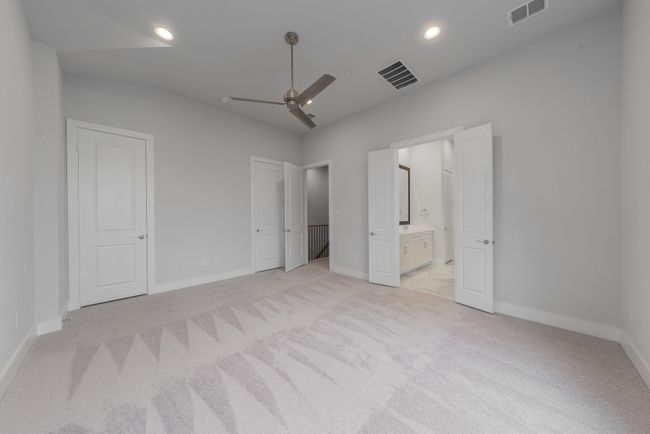 Unfurnished bedroom featuring visible vents, baseboards, light carpet, and connected bathroom | Image 23