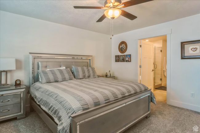 Bedroom featuring carpet floors, ensuite bath, a ceiling fan, and baseboards | Image 17