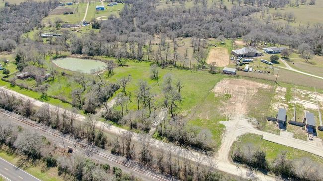 Aerial view of property and surrounding area featuring a nearby body of water and rural landscape | Image 4