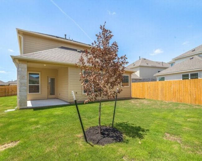 Rear view of house with a fenced backyard, a patio area, and roof with shingles | Image 18