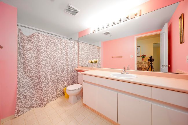 Full bath featuring toilet, vanity, tile patterned floors, and curtained shower | Image 27